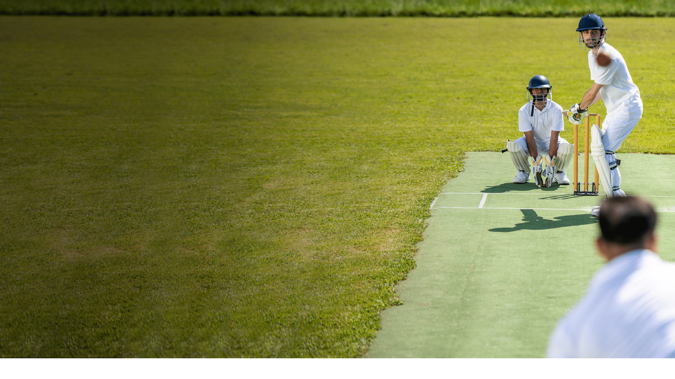 Photo of a cricket batsman ready to strike the ball that was thrown by the