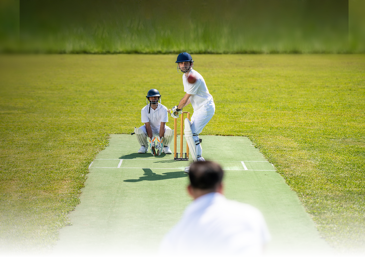 Photo of a cricket batsman ready to strike the ball that was thrown by the