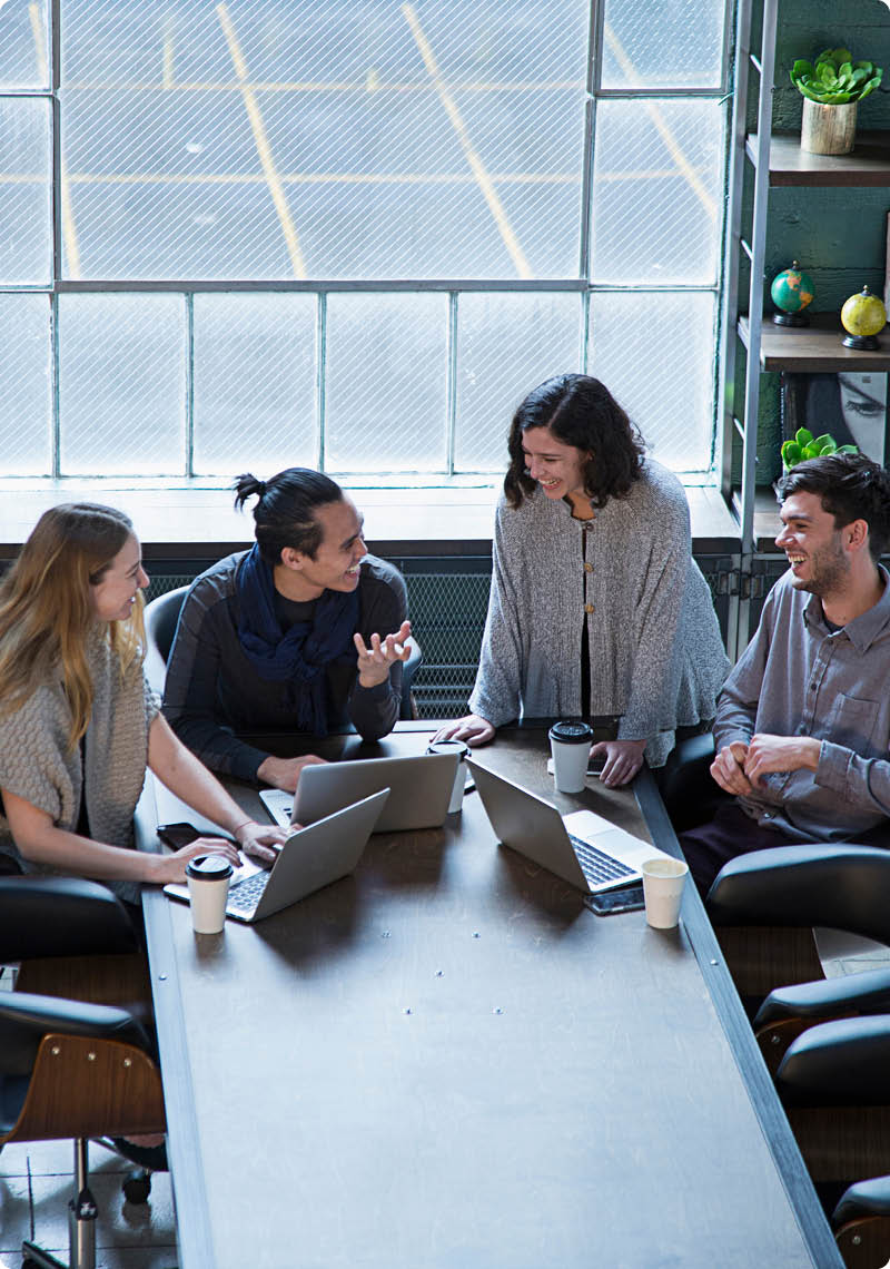 Smiling business people talking in office meeting