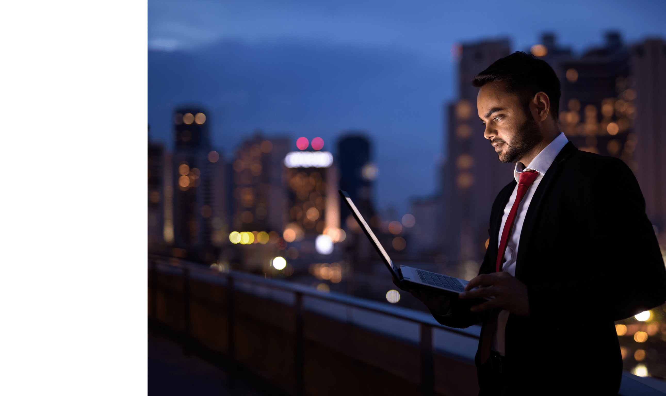 Portrait of young Indian businessman against view of the city in Bangkok Thailand horizontal shot