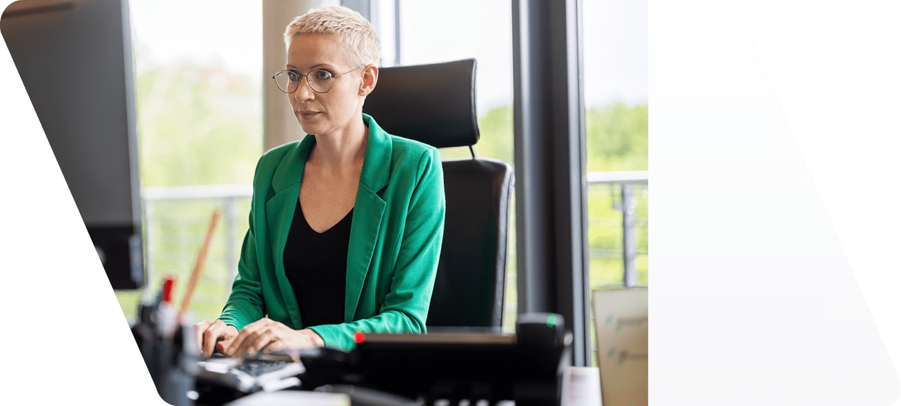 Businesswoman working at her desk  Female professional working on the desktop computer in office 
